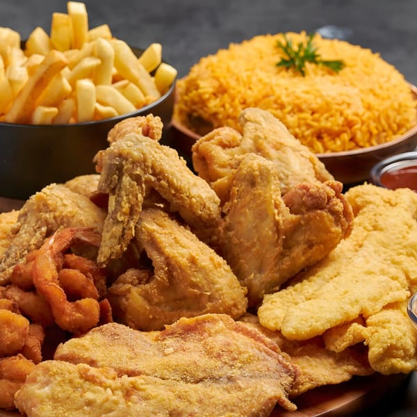 Jaws Hot Chicken & Seafood platter with fried chicken, shrimp, fish, fries, and rice.