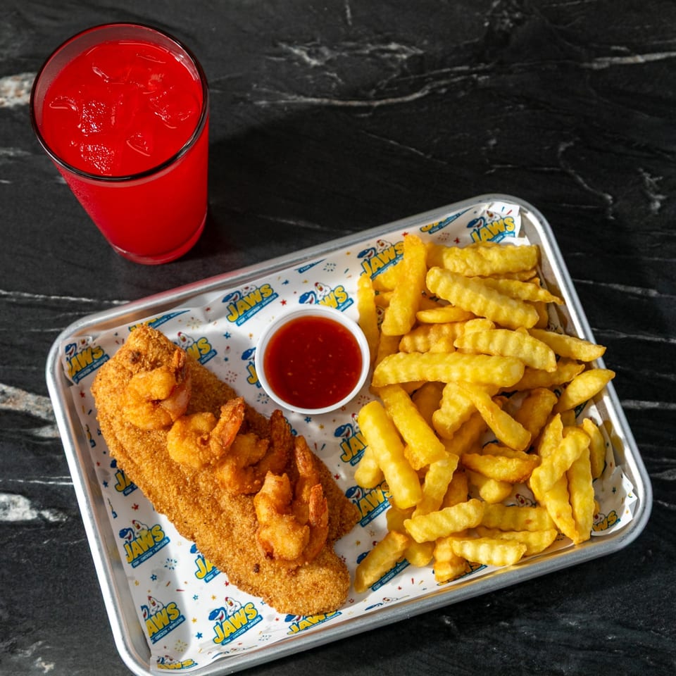 Breaded fish fillet, fried shrimp, crinkle-cut fries, dipping sauce, and a red iced drink on a branded tray.